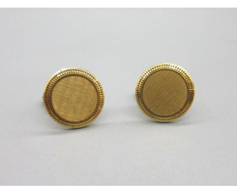 Patek Philippe 'Calatrava' 18ct yellow gold cufflinks, the textured centre surrounded by a hobnail border, stamped 750, 22.69