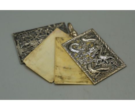 Early 20th century Chinese silver cylindrical box and cover, all over embossed with dragons in clouds, stamped KK 90, H5.5cm 