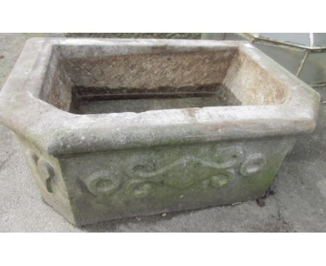 Weathered composition rectangular trough style planter, with canted front, relief decorated with hearts, roundels and scrolls