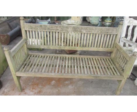 Teak slatted garden bench, top rail carved "The kiss of the sun for pardon, the song of the birds for mirth, one is nearer Go