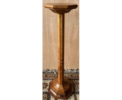 Robert Mouseman Thompson of Kilburn- an oak flower stand, octagonal top on faceted column and stepped octagonal base, carved 