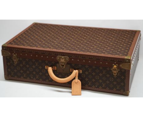 Louis Vuitton trunk case, brown monogram canvas, rounded leather carrying handle, with gold coloured strapwork and studding, 