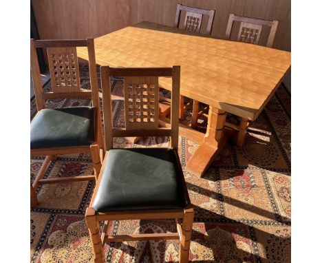 Carthorse Furniture Thirsk - an oak dining table, adzed rectangular top on octagonal supports with sledge feet and floor stre