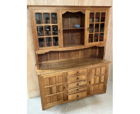 Phil Cartwheelman Langstaff, Carthouse Furniture Thirsk - a panelled oak dresser, back with two bevelled glass doors and shel