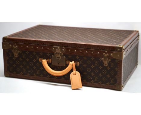 Louis Vuitton trunk case, brown monogram canvas, rounded leather carrying handle, with gold coloured strapwork and studding, 