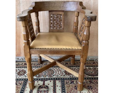 Robert Mouseman Thompson of Kilburn - an oak Monks chair, curved top rail with three lattice splats and brass nailed leather 