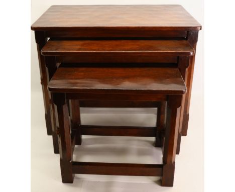 Robert Mouseman Thompson of Kilburn - a nest of three oak rectangular tables with adzed tops, octagonal supports with stretch