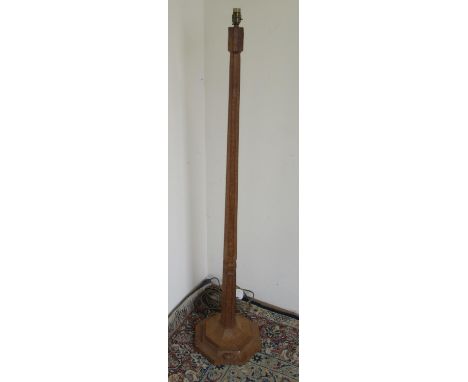 Robert Mouseman Thompson of Kilburn - an oak standard lamp, adzed octagonal tapering column on stepped base, carved with sign