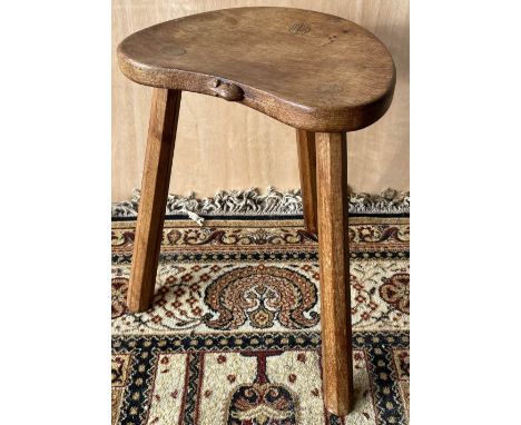 Robert Mouseman Thompson of Kilburn - an oak cow stool, kidney shaped top on three octagonal outsplayed supports, carved with