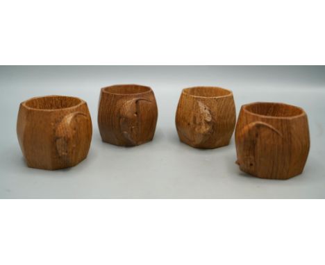 Robert Mouseman Thompson of Kilburn - a set of four octagonal oak napkin rings, each carved with signature mouse, H5cm (4)Shi