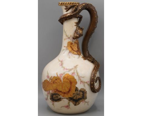 Royal Worcester ewer, ivory scaled painted with green and gilt leaves, flowers, with a wraparound gilded dragon handle, H29cm