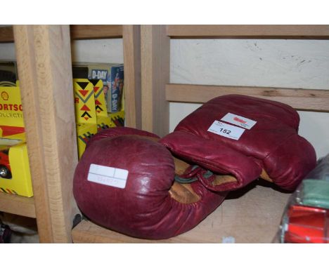 A pair of vintage red leather laced boxing gloves, marked Eton 8oz