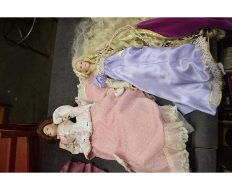 A porcelain doll on stand, formed as a Victorian lady in pink dress and floral jacket. Height approximately 55cm together wit