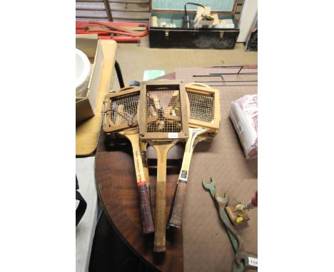 Five vintage tennis rackets with wooden clamps