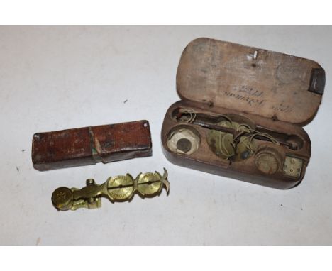 An antique wooden cased set of scales, weights marked with anchor and lion and a set of sovereign scales