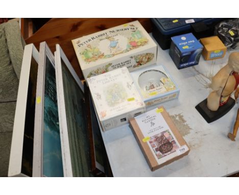 A Wedgwood Peter Rabbit nursery set; a Peter Rabbit library; a Peter Rabbit bowl and a cast iron door knocker