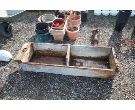 A vintage wooden two section feed trough