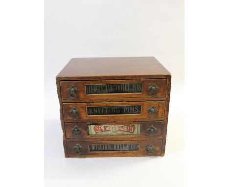 A vintage sewing cabinet with four labelled drawers, including Needles and Toilet Pins, and Knitting Pins. Also marked for 'W