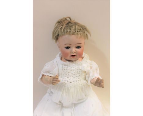 A Simon &amp; Halbig character doll with weighted blue eyes, open mouth and bent limb body. Arms and feet restored and finger