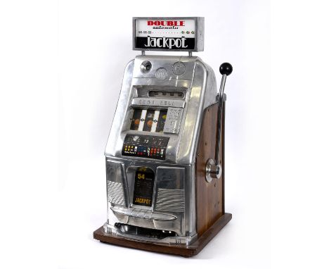 A vintage slot machine, a Sega Bell Double Automatic, with large pull down lever and wooden metal case. With its key and some