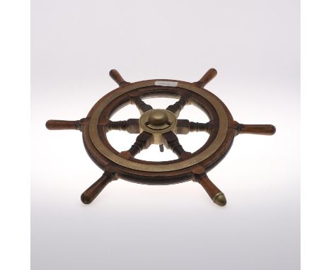 The wooden wheel with six handles (one with brass end), with a brass band and central boss. 61cms across.  *CR:  Quite worn i