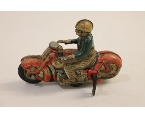 A Curvo 1000 Schuco tin plate figure of a man on a motorbike, with a clockwork mechanism and with its original key. In workin