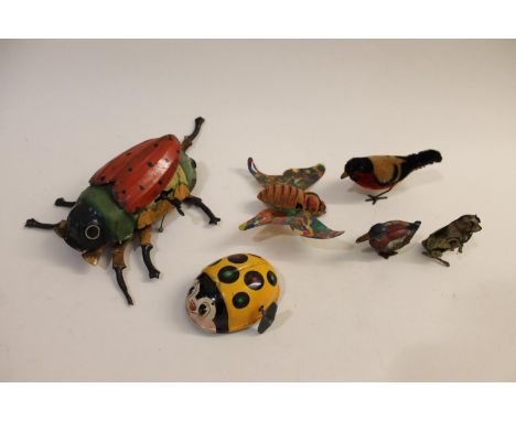 A large clockwork tin plate ladybird (body 15cms long, mechanism working), also with a clockwork Bullfinch, a Japanese clockw