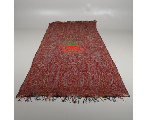 A woollen vintage Paisley shawl, the centre with a repeating floral design on a red and green ground, with a typical floral d