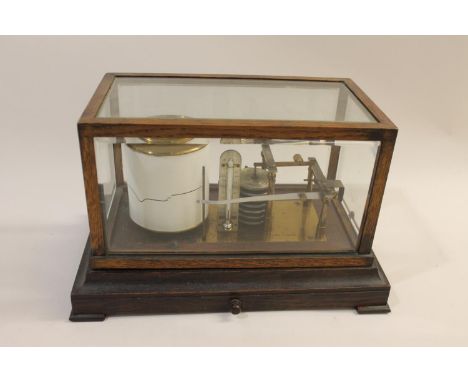 An oak cased barograph with a single drawer, the cylinder with a clockwork mechanism. Marked, Negretti &amp; Zambra, London. 