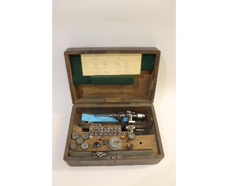 A watch makers lathe in a fitted oak box with a range of accessories, with a plaque inside 'British Made, RAW Co'. Also with 
