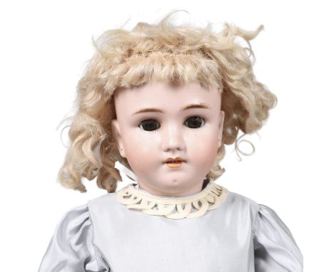 A large doll with weighted brown eyes, open mouth and pierced ears. With a jointed composition body and with its original Beb