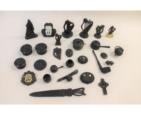 An interesting group of bog oak items, including two harp's, various lidded boxes, a large carved brooch with latin motto (st