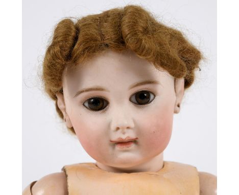 Circa 1881-1886, with almond shaped brown fixed eyes, closed mouth and applied pierced ears. With a ball jointed composition 