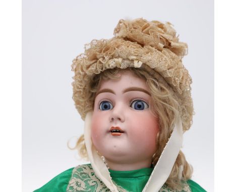 A large doll with weighted blue eyes, open mouth and pierced ears. With a jointed composition body and fully clothed includin