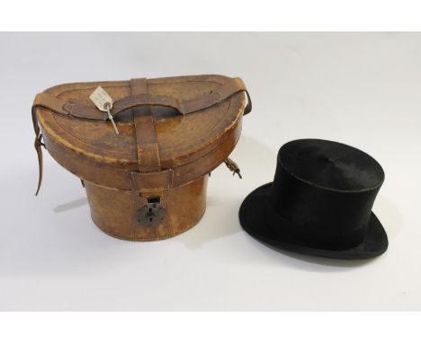 A leather hat box with brass lock and carrying handle, stamped to the handle 'Lincoln Bennett &amp; Co, London'. With a black