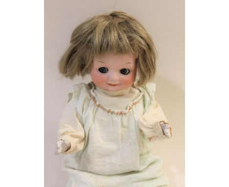 Model No 323, with weighted blue googly eyes and closed painted mouth. With composition limbs, impressed marks 'AM, Germany, 