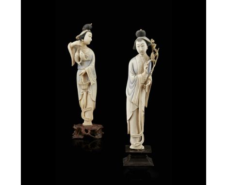 PAIR OF IVORY FIGURES OF FEMALE IMMORTALSREPUBLIC PERIOD the first holding a flowering lotus branch, the second holding two c