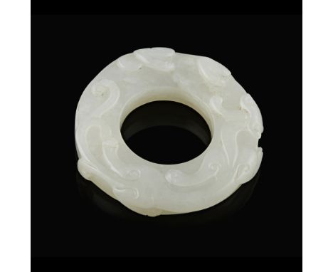 WHITE JADE 'CHILONG' DISCthe disc with a large aperture, the exterior carved in low relief with a sinuous chilong dragon, the