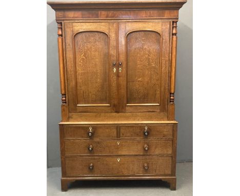 Victorian Welsh pale oak press cupboard, the moulded cornice above two blind panelled doors, and key, the interior revealing 