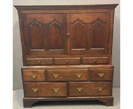 Early 19th century Welsh oak Cardiganshire two stage press cupboard, the moulded cornice above two blind panelled doors with 