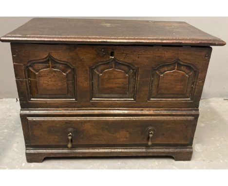 18th century Welsh oak coffwr bach, the iron hinged moulded lid above three ogee fielded panels, the projecting base with sin