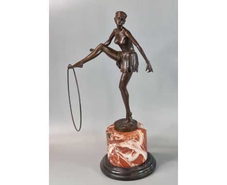 After D Alonzo, an Art Deco style bronze of a semi-nude female dancer with hoop on he outstretched foot, with foundry mark, s