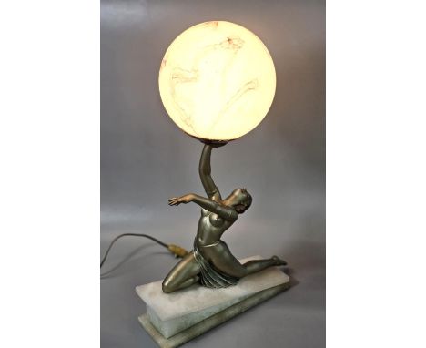 Art Deco gilt spelter table lamp, modelled as a kneeling dancer with one arm upstretched, holding an opaque ice glass shade b