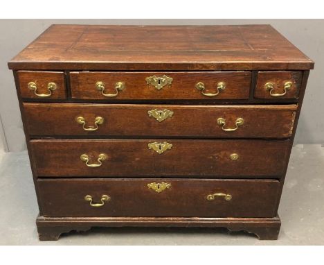 18th century oak chest of drawers, the moulded top above an arrangement of four long and two small drawers with brass locks a