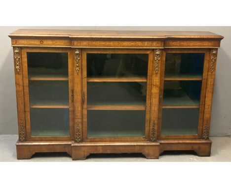 Victorian walnut and marquetry inlaid break front credenza, the moulded top above three glazed doors, the interior revealing 
