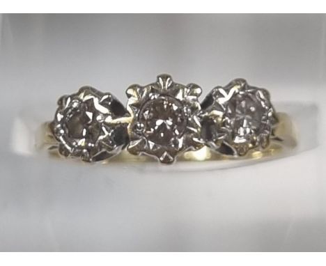 18ct gold three stone diamond ring in crown setting, the central stone 0.30 carat.  2.9g approx.  Size K.  (B.P. 21% + VAT) 