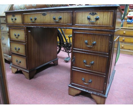 A Mahogany Pedestal Desk, with red leather sciver, two top drawers fall front drawer, pedestals with cupboard door and drawer