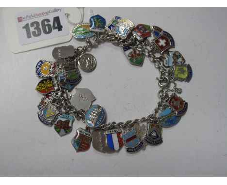 A Curb Link Bracelet, suspending numerous enamel souvenir shield pendants etc.