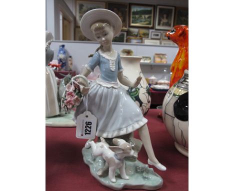 Lladro Pottery Figure Group of Girl Carrying Basket by Playful Puppy, impressed K-26 E 25cm high.