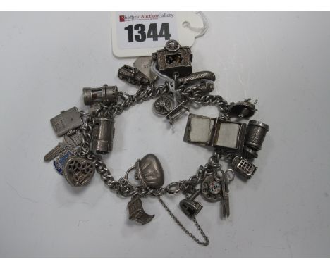 A Curb Link Charm Bracelet, suspending numerous novelty charm pendants, including miners lamp, spinning wheel, telephone dial